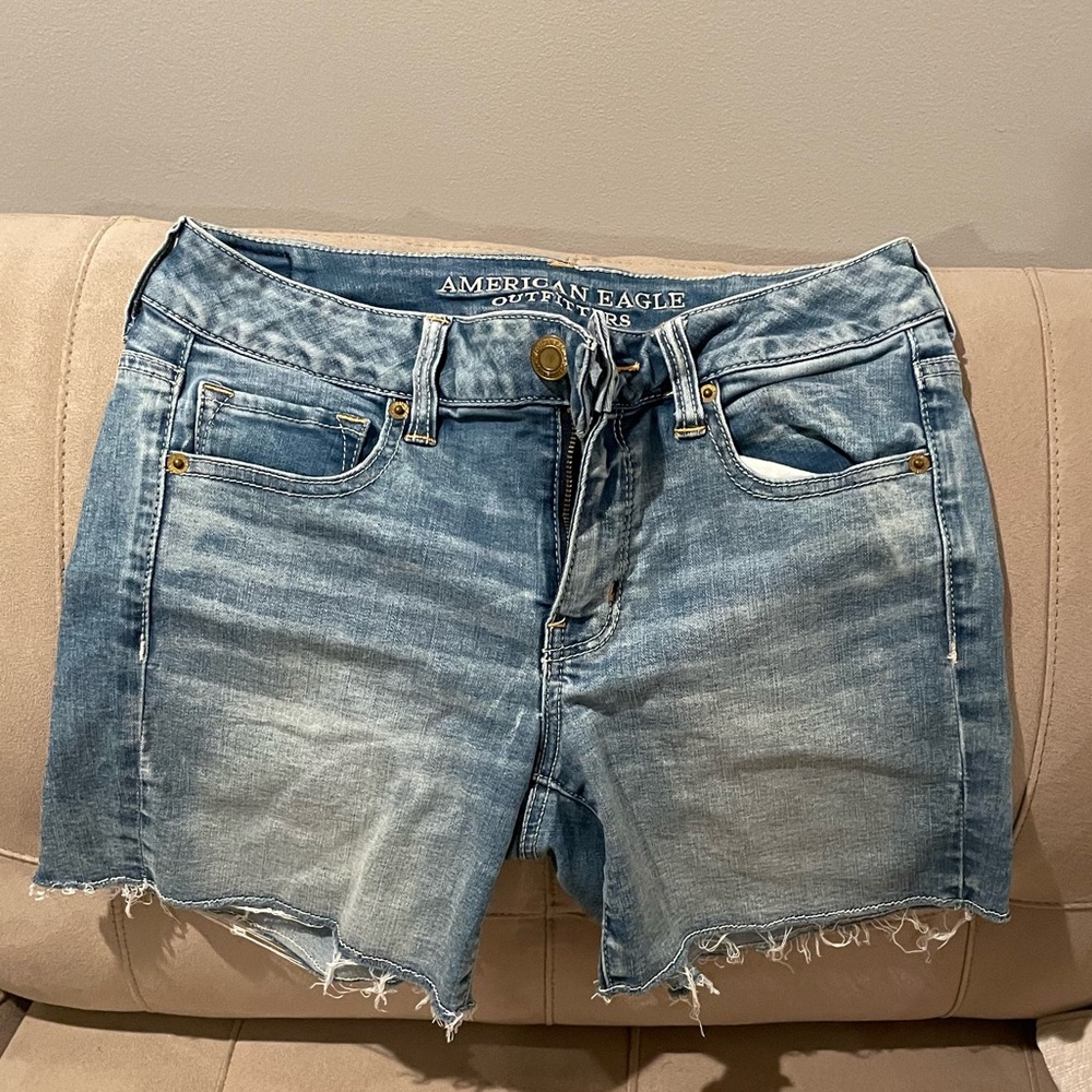 Distressed mid length jean shorts